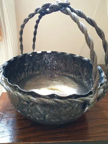 Decorative vintage metal basket with braided handles