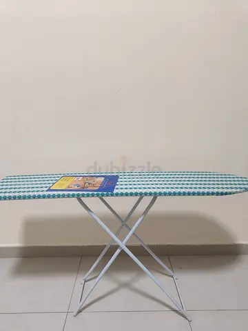 Ironing board in brand new — adjustable height, cover included - stain free and absolutely NEW