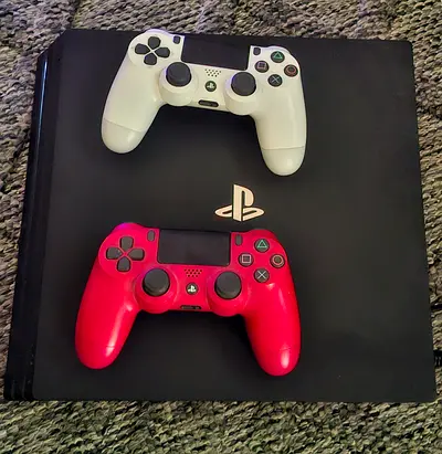 PlayStation Pro 4 Slim with two DualShock 4 controllers (white + red) - good condition