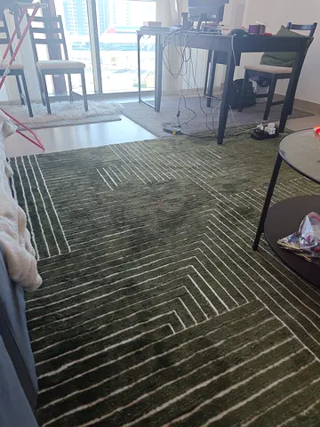 Assortment of rugs - large green geometric, navy $%! rug, 2 white $%!, 2 blue carpets