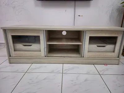 Moving Out Sale: Light wood TV cabinet with glass doors and shelves - good condition