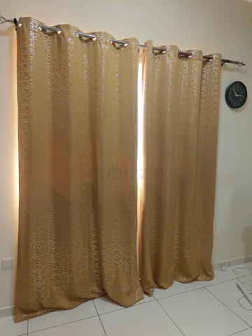 Pair of patterned gold eyelet curtains