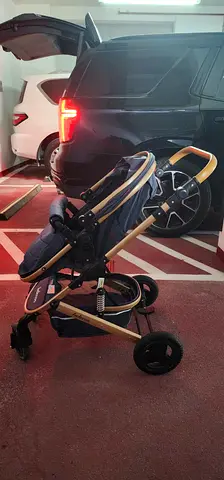 Lightweight gold-frame baby stroller with reclining seat and storage basket
