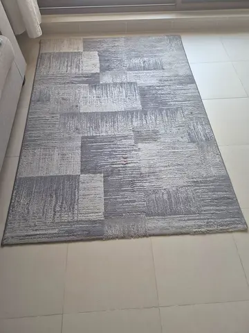 Grey Carpet Rug. 4 Cushions available for free with it if interested.