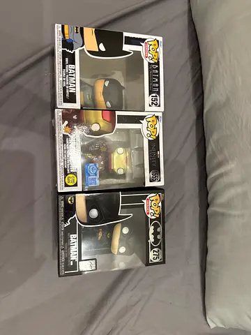 3 FUNKO POPS. THE TWO BATMAN FUNKO POPS DONT HAVE THE CLEAR CASE OTHER WISE PERFECT.