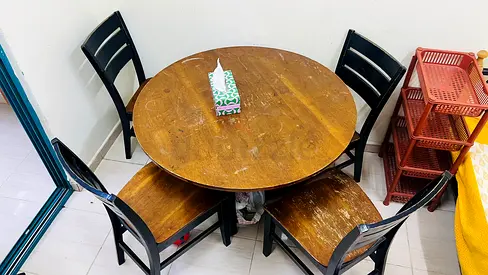 Used round wooden dining table with 4 chairs — solid compact set