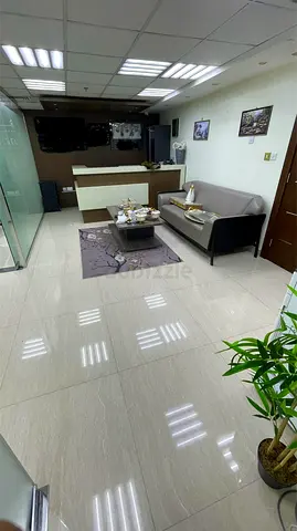 Fully Furnished Small Office Reception Area with Sofa and Desk