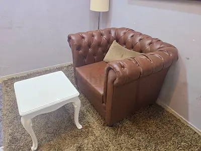 Brown leather Chesterfield armchair with cushion