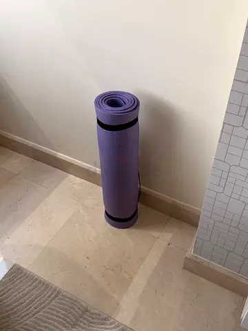 Purple yoga mat with strap