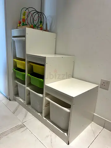 IKEA White nursery storage shelf with colored toy bins