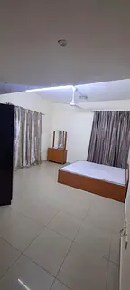 Furnished master bedroom with attached bathroom and balcony