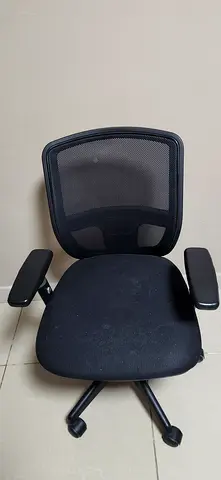 Used black mesh office chair with headrest and armrests
