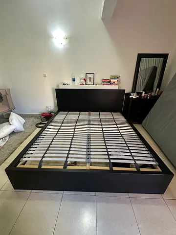 IKEA MALM King size Bed Frame and storage compartment behind.