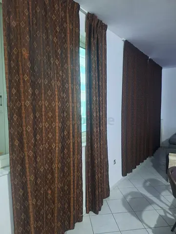 Brown patterned full-length curtains -
