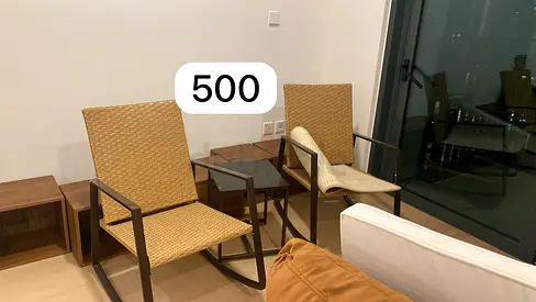 Pair of woven rattan-style lounge chairs with metal frames - used