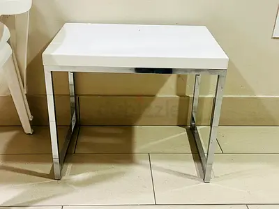 Small white side table with chrome legs