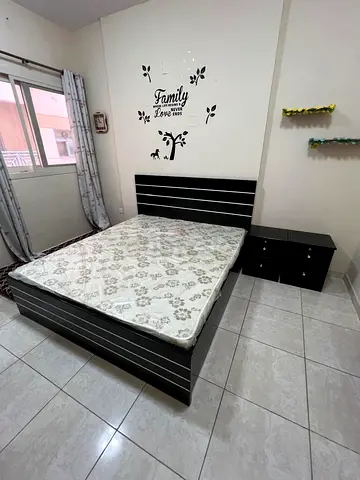Queen bed frame with mattress and matching bedside drawers - black