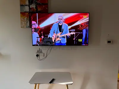 55-inch LED Smart TV wall-mounted in good condition