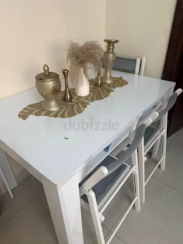 White wooden dining table with 4 folding chairs - compact set from IKEA