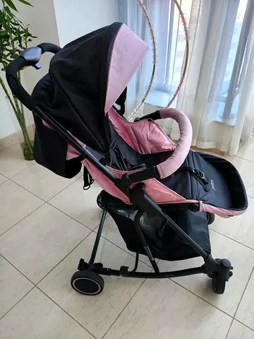 Lightweight pink and black baby stroller - good condition