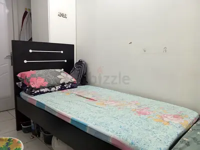 Single wooden bed with mattress