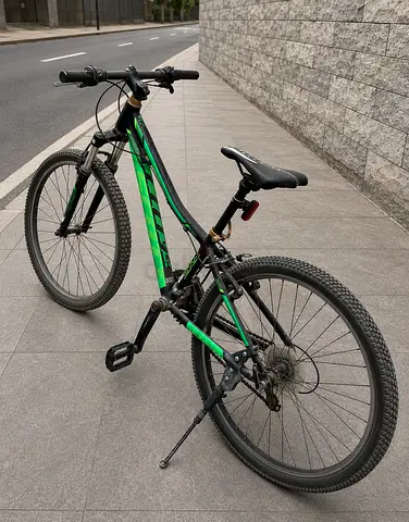 Used green full-suspension mountain bike - 26 wheels