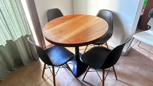 Round wooden dining table with 4 black chairs - good condition