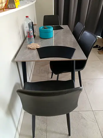 Compact marble-top dining table with 4 black chairs - good condition