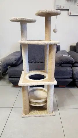 Beige multi-level cat tree with hammock and scratch posts