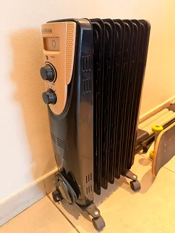 Used Portable Oil-Filled Radiator Heater - 9 Fins, Casters, Adjustable Thermostat