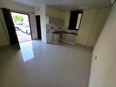 For annual rent in Ajman Corniche, a ground floor studio with a large area and excellent lighting, with split air conditioning and a vibrant location