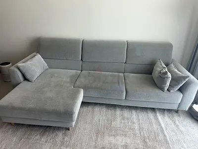 Light grey L-shaped fabric sofa with chaise
