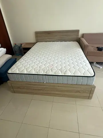 Wooden double bed frame with mattress and storage drawer - good condition