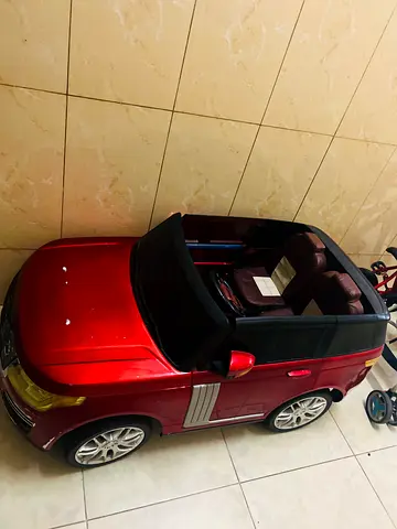 Red electric ride-on toy car for kids (2-seater style)need to change battery