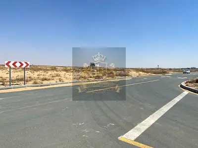 For sale in Sharjah Rawdat Al Qurt area Residential investment plot, 3,100 square feet, corner plot, on two adjacent streets