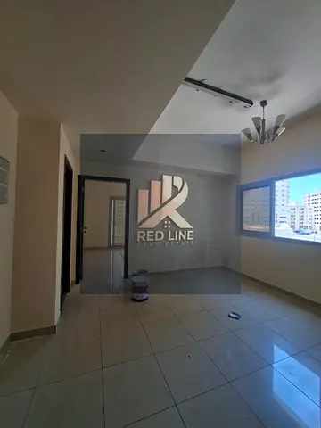 For Rent: 1 Bedroom Apartment in Al Majaz 3 in a prime location. The apartment features a balcony in the bedroom, a large living room window offering