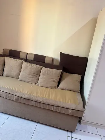 2-seater fabric sofa in beige/brown with cushions — good condition