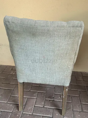 Light grey upholstered dining chair with wooden legs (used)