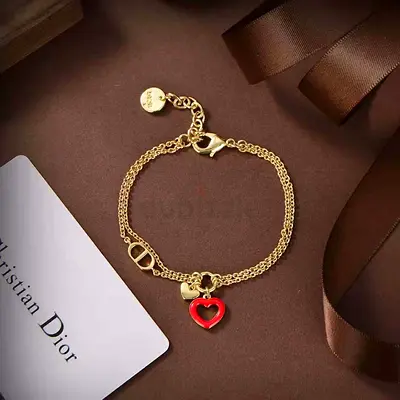 Christin dior Gold-tone double chain bracelet with red heart charm