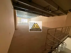 a mezzanine-level warehouse with ample space in a vibrant industrial area, providing an ideal enviro