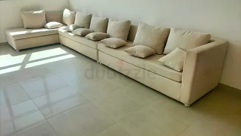 Large L-shaped Beige Fabric Sofa - Comfortable 6-seater with Cushions
