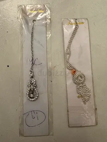 Two silver-tone decorative hair chains / matha patti pieces (new, in packaging)