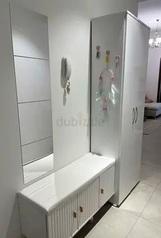 White hallway storage bench with tall wardrobe cabinet , shoe storage