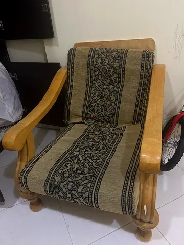 Solid wood single armchair with patterned seat cover - good condition