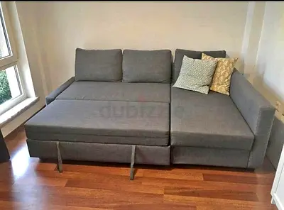 Light grey L-shaped sofa bed — good condition