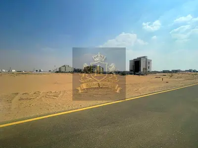 Commercial land for sale on a prime 54-meter wide street in Sharjah – Rawdat Al Qurt area