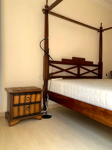 Wooden queen bed with side drawer and a large drawer
