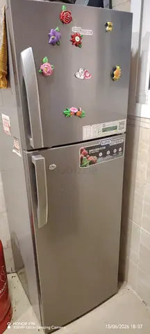 Silver double-door refrigerator in good working condition