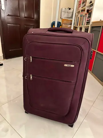 28 inch Purple medium soft-shell travel suitcase with wheels - good condition