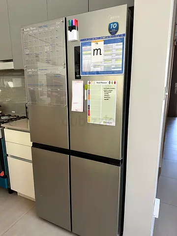 Large stainless steel 4-door refrigerator in excellent condition